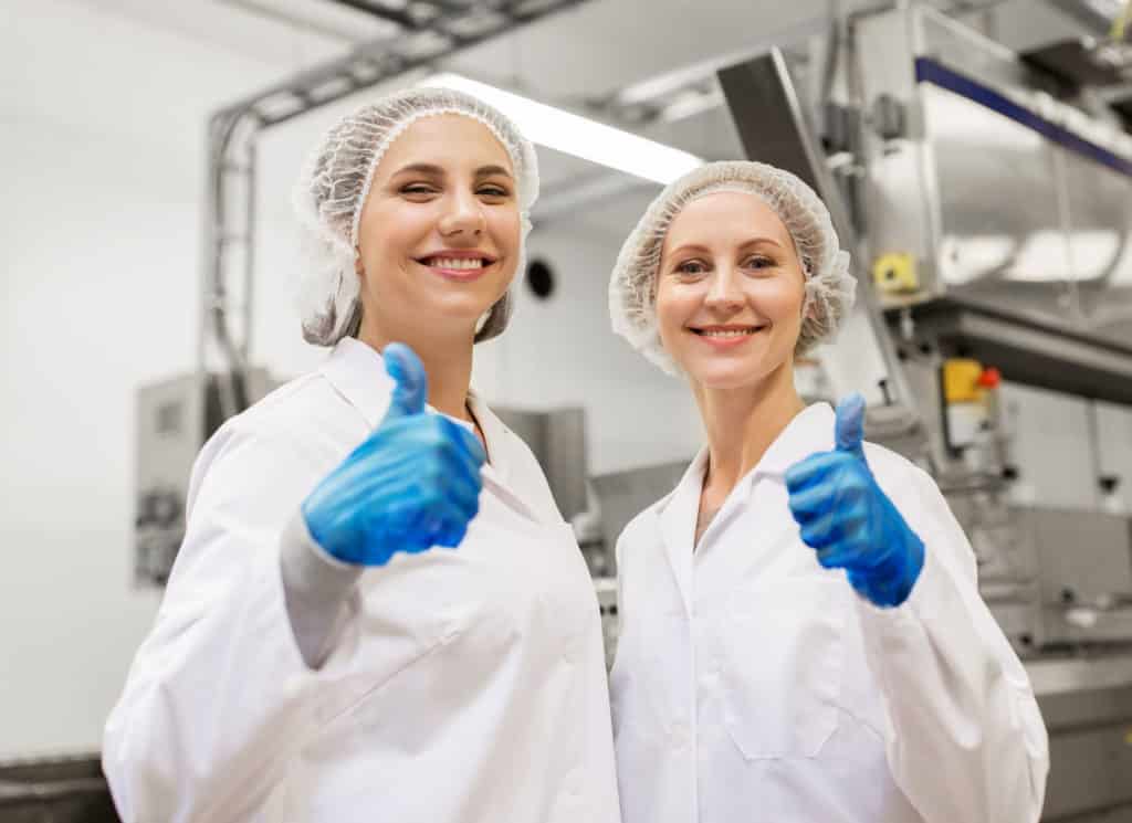 Happy women technologists at food factory